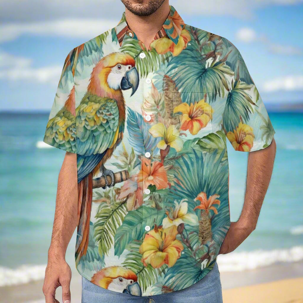 Man wearing a colorful tropical Hawaiian shirt with parrot and floral design standing on the beach in Waikiki