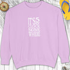 Purple sweatshirt with 'It's 5 o'clock somewhere' text on a wooden surface.
