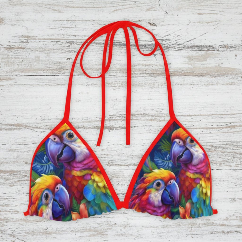 Colorful parrot-themed bikini top on a rustic nautical wood background