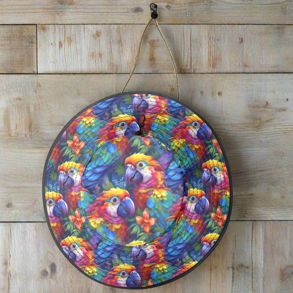 Colorful parrot-head bucket sun hat hanging by its strap on a rustic nautical wood wall