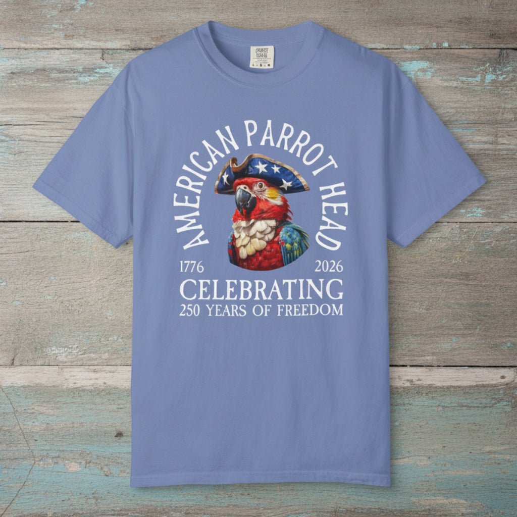 Blue t-shirt with a parrot graphic and text on a nautical wood background