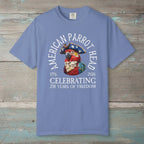 Blue t-shirt with a parrot graphic and text on a nautical wood background