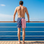 Person wearing American flag patterned swim shorts on a white background