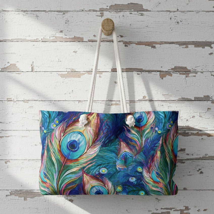 Colorful peacock feather patterned bag hanging on a wooden wall.
