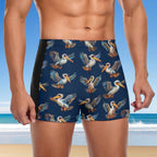 Dude wearing navy swim shorts with pelican pattern on a beach background