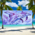 Pink and purple dolphins on a on a sweet beach towel hanging on a close line in a tropical paradise