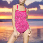 Women's Swimwear Model wearing a Pink Dolphin One Piece Standing on the Beach 