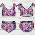 Multicolored seahorse-patterned bikini set on a rustic nautical wood background