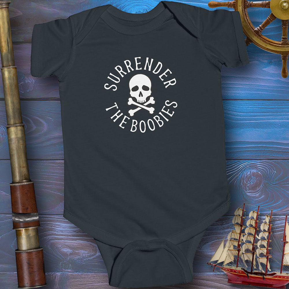 Black baby onesie with 'Surrender The Boobies' print on a wooden background with ship and cannon.