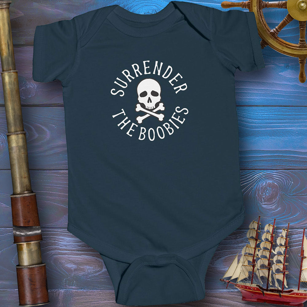 Navy blue baby onesie with skull and crossbones design on a wooden background with ship and cannon.