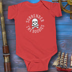 Red baby onesie with skull and crossbones design on a wooden background with ship and cannon.