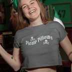 Woman in a bar wearing a 'Pirate Pillows' shirt with a green beer glass.