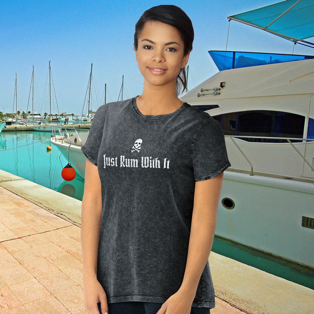 Woman wearing a Denim Pirate T-Shirt with 'Just Rum With It' text at a marina.