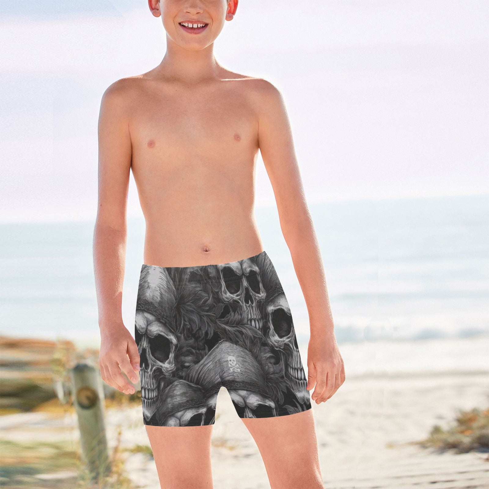 Child wearing black pirate skull-patterned swim shorts on a Caribbean Island beach.