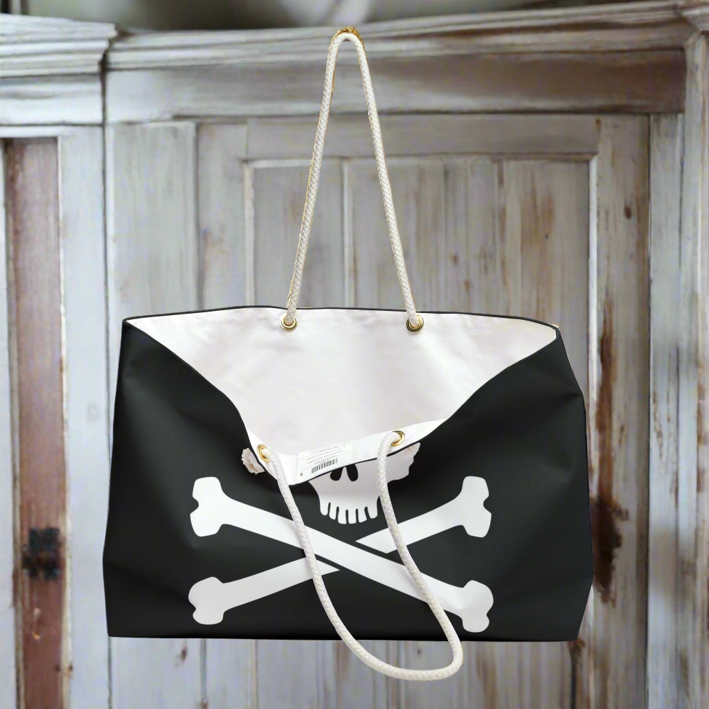 Jolly roger tote bag hanging from a hook in the captain's quarters of a pirate ship