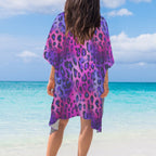 Person wearing a purple leopard print cover-up on a beach