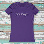 Purple t-shirt with 'Sea Vixen salty af' text on a rustic nautical wood background