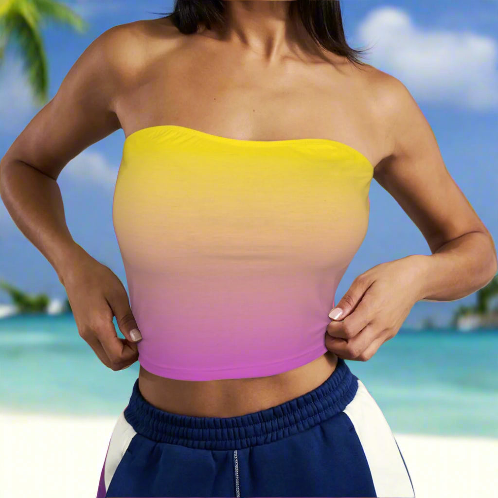 Gradient strapless top worn by a swimwear model against a beach island background