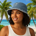 Person wearing a blue Palm Tree bucket hat with frayed edges on a tropical island beach