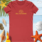 SHELL YEAH SUNSHINE women's summer t-shirt in vibrant red against beach-themed backdrop, perfect for sunny outings.