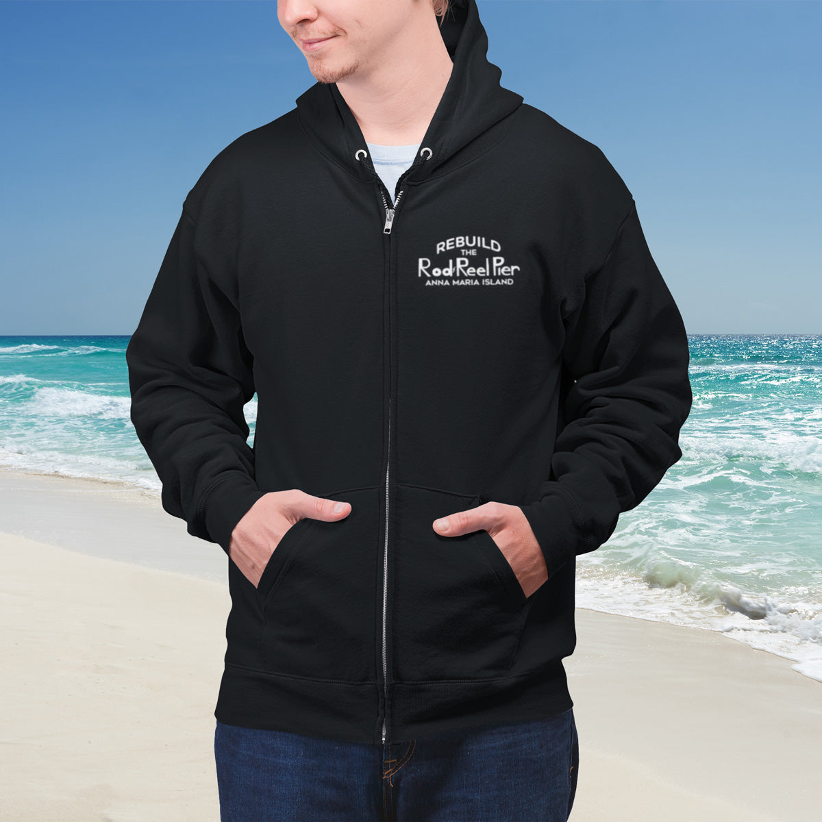 Person wearing a black hoodie with text on Anna Maria Island beach