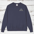 Navy blue Fundraiser sweatshirt with a logo on a wooden surface