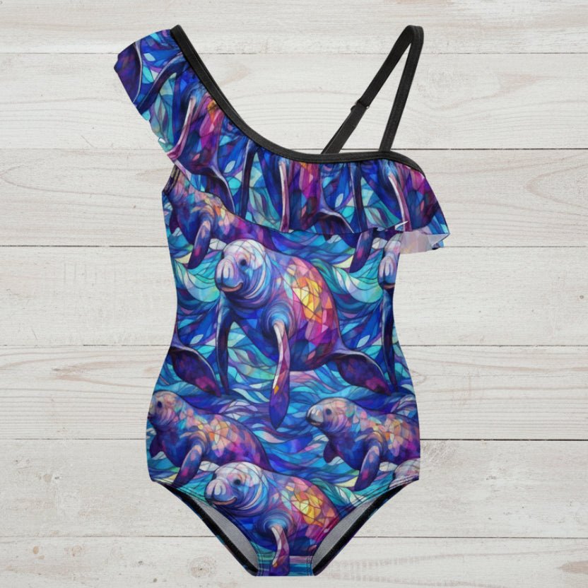 Colorful swimsuit with manatee design on a nautical wood background