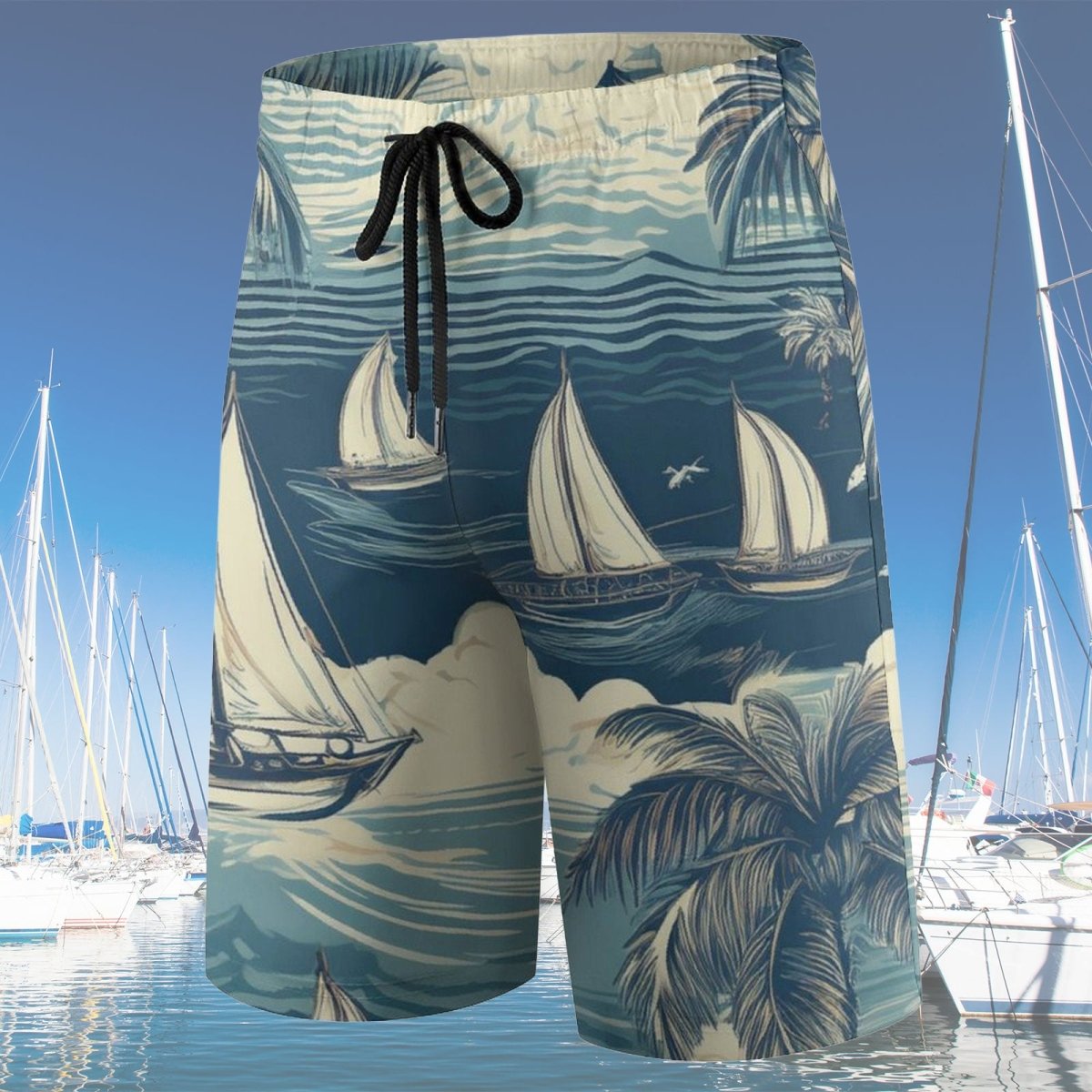 Beach shorts with sailboat and palm tree pattern on a background of boats and blue sky.
