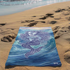 Zen Mermaid Beach Towel laying in the sand next to the waves