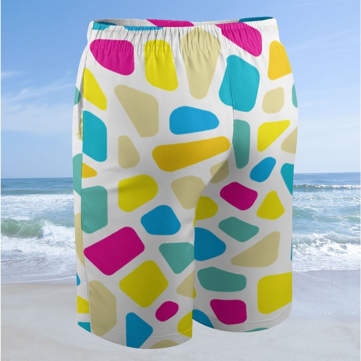 Colorful geometric-patterned shorts on a beach with ocean view