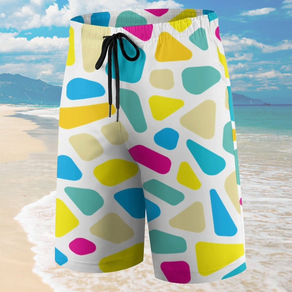 Colorful geometric patterned shorts on a beach with ocean and sky background