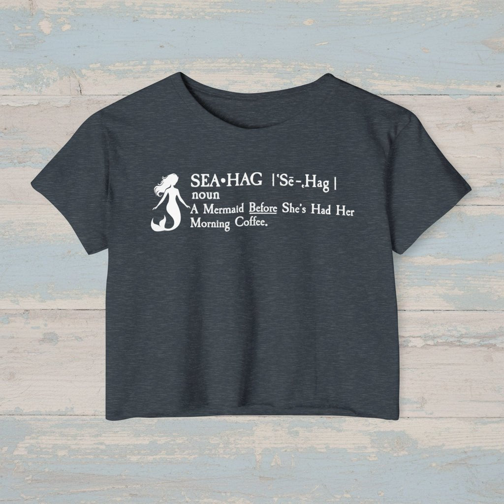 Black crop top with white mermaid graphic and text on a rustic woodbackground