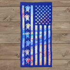 American flag-themed towel with turtle designs on a rustic wood background