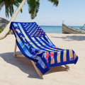 Colorful beach towel with American flag design on a lounge chair at the beach.