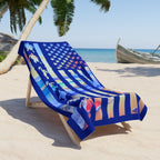 Colorful beach towel with American flag design on a lounge chair at the beach.