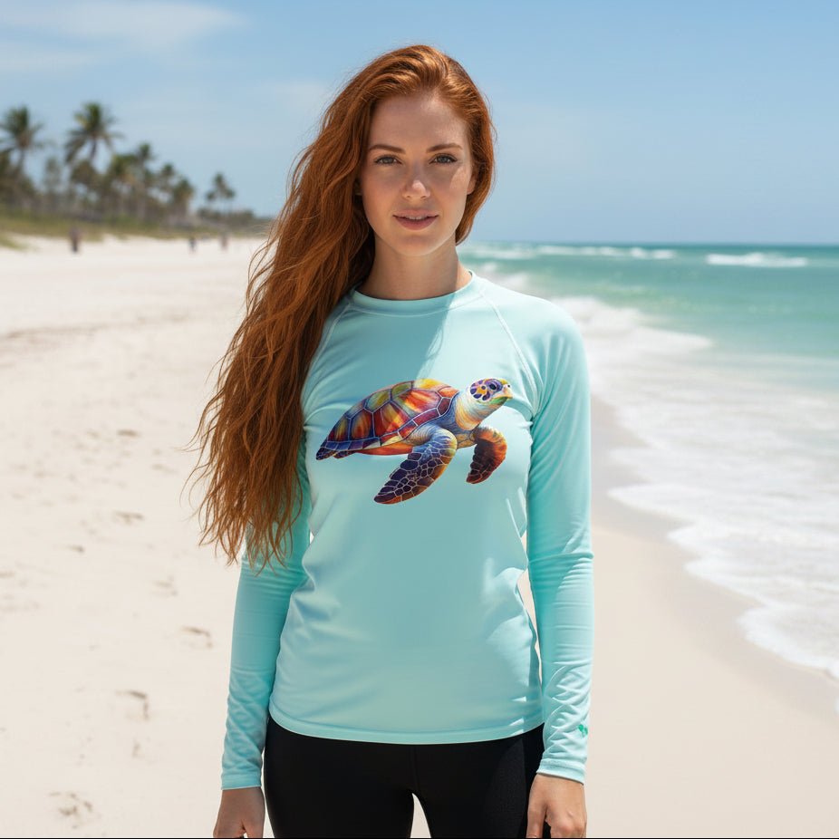 Woman wearing a light blue long-sleeve sun rashie with a sea turtle design on Fort Myers Beach