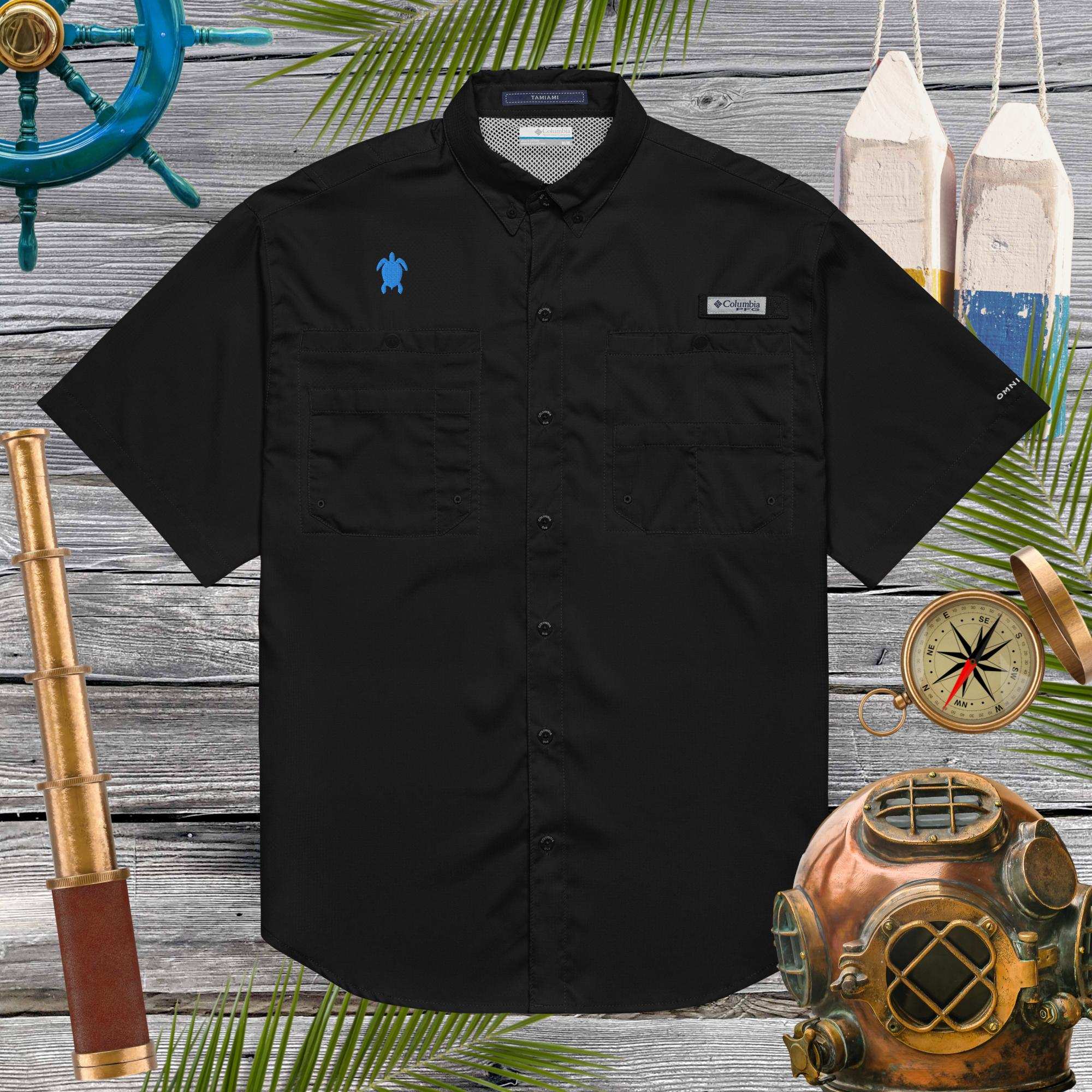 Black short-sleeve shirt with embroidered sea turtle on a wooden background with nautical-themed decor.
