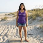 Woman wearing a purple 'SeaVixen' tank top on a sandy beach.