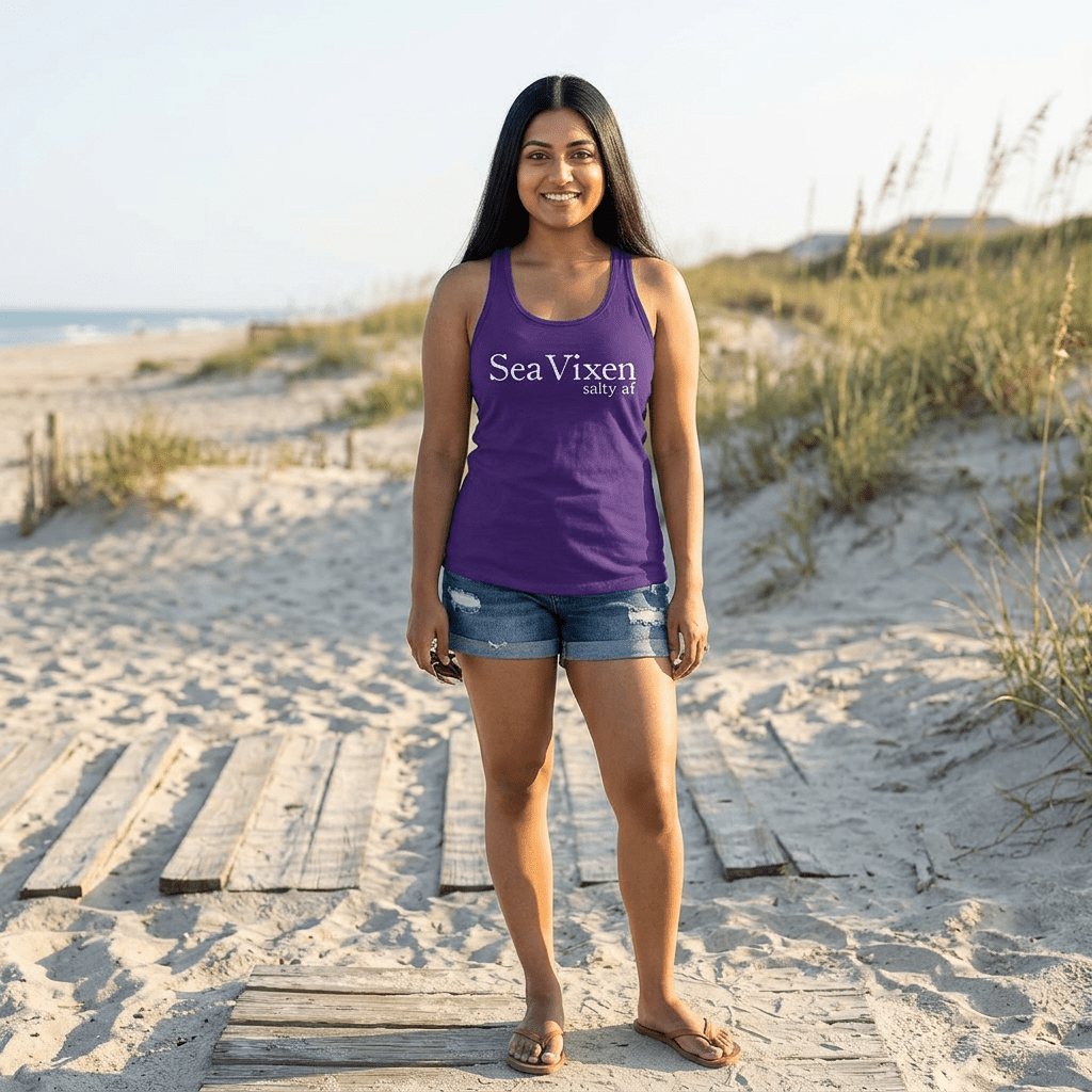 Woman wearing a purple 'SeaVixen' tank top on a sandy beach.