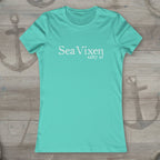 Turquoise t-shirt with 'Sea Vixen salty af' text on a rustic nautical wood background
