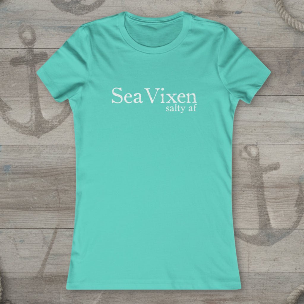 Turquoise t-shirt with 'Sea Vixen salty af' text on a rustic nautical wood background