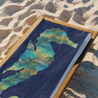 Navy Blue beach towel laying on a beach lounger on a sandy beach