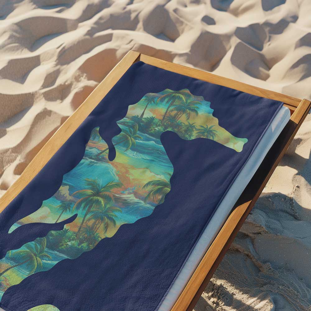 Navy Blue beach towel laying on a beach lounger on a sandy beach