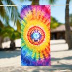 Cool Tie Dye Beach Towel with sea turtle silhouette in the center, hanging on a line outside an Island tiki hut