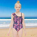 Girl wearing a colorful seahorse-patterned swimsuit on a California beach