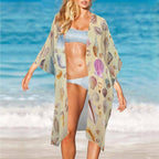 Woman in a shell-patterned cover-up and bikini on a beach