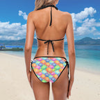 Woman wearing a colorful bikini with a tropical beach background