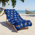 Shaka wave beach towel hanging loose on a beach lounger with the sea and boat behind