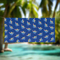 Blue Beach towel with shaka pattern hanging on a line on a tropical island