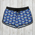 Blue patterned shaka shorts on a rustic wood background
